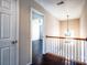 Upstairs hallway features hardwood floors, white railings, and natural light at 2017 Bridleside Dr, Indian Trail, NC 28079