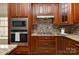 Close-up of kitchen featuring stainless steel appliances and a stylish backsplash at 2017 Bridleside Dr, Indian Trail, NC 28079