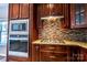 Kitchen detail featuring stainless steel appliances, granite countertops, and backsplash at 2017 Bridleside Dr, Indian Trail, NC 28079