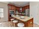 Kitchen island with breakfast bar seating, stainless appliances and granite countertops at 2017 Bridleside Dr, Indian Trail, NC 28079