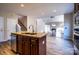 Kitchen island with stainless steel appliances and view of the living room fireplace at 2017 Bridleside Dr, Indian Trail, NC 28079