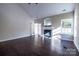 Bright living room with a fireplace, French doors, hardwood floors, and large windows at 2017 Bridleside Dr, Indian Trail, NC 28079