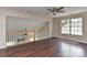 Spacious loft area with hardwood floors, ceiling fan, and railing overlooking the downstairs area at 2017 Bridleside Dr, Indian Trail, NC 28079