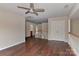 Spacious loft area with hardwood floors, ceiling fan, and railing overlooking the downstairs area at 2017 Bridleside Dr, Indian Trail, NC 28079