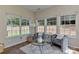 Bright sunroom features neutral walls, tile floors, and multiple windows with backyard views at 2017 Bridleside Dr, Indian Trail, NC 28079