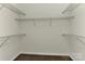 Empty walk-in closet featuring wire shelving on three sides, ready for customization and ample storage at 2017 Bridleside Dr, Indian Trail, NC 28079