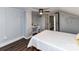 Bedroom with angled walls, light gray walls, wood floors, and small desk space at 214 W Elm St, Wingate, NC 28174