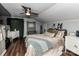 Bedroom featuring wood floors, a ceiling fan and a neutral bed with green accents at 214 W Elm St, Wingate, NC 28174