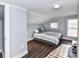 Bedroom with angled walls, light gray walls, wood floors and neutral bed at 214 W Elm St, Wingate, NC 28174