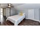 Bedroom with wood floors, light gray walls, neutral comforter, and a ceiling fan at 214 W Elm St, Wingate, NC 28174