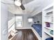 Bedroom featuring wood floors, gray walls, bed with built-in shelf, and a ceiling fan at 214 W Elm St, Wingate, NC 28174