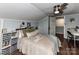 Cozy bedroom featuring soft pastel walls, modern ceiling fan and decor, and comfortable furniture at 214 W Elm St, Wingate, NC 28174