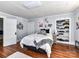 Comfortable bedroom featuring wood floors, and a built in shelving unit at 214 W Elm St, Wingate, NC 28174