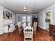 Traditional dining room with hardwood floors, white paneled ceiling, and white shelving unit at 214 W Elm St, Wingate, NC 28174
