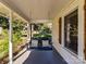 Welcoming covered front porch featuring a classic porch swing with decorative pillows at 214 W Elm St, Wingate, NC 28174