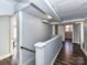 Hallway with wood floor, gray walls, white baseboards and banister at 214 W Elm St, Wingate, NC 28174