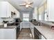 Functional kitchen featuring white cabinets, tile flooring, and lots of natural light at 214 W Elm St, Wingate, NC 28174
