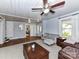 Comfortable living room with hardwood floors, a ceiling fan, and a cozy gray couch at 214 W Elm St, Wingate, NC 28174