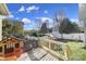 Backyard deck with a grill, wooden playhouse, a blue slide, and a white fence at 224 Mills Ln, Fort Mill, SC 29708