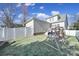 The backyard features a white fence, a swing set with a blue slide, and grass at 224 Mills Ln, Fort Mill, SC 29708