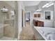 Bathroom with tiled shower, soaking tub, and double vanity at 224 Mills Ln, Fort Mill, SC 29708