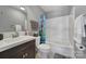 Bathroom with tiled shower and tub and dark vanity at 224 Mills Ln, Fort Mill, SC 29708