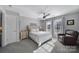 Sunlit bedroom with carpet, a ceiling fan, and a cozy armchair at 224 Mills Ln, Fort Mill, SC 29708
