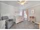 Charming Bedroom with crib, chair, and colorful bookshelf at 224 Mills Ln, Fort Mill, SC 29708
