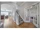 Bright hallway with staircase, showcasing hardwood floors and access to a playroom at 224 Mills Ln, Fort Mill, SC 29708