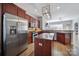 Open-concept kitchen features granite countertops, stainless steel appliances, and ample cabinet storage at 224 Mills Ln, Fort Mill, SC 29708