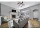 Comfortable living room with a fireplace, TV, a ceiling fan and lots of natural light from the window at 224 Mills Ln, Fort Mill, SC 29708