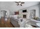 Open-concept living area with a fireplace, ceiling fan, living room seating, and hardwood flooring at 224 Mills Ln, Fort Mill, SC 29708