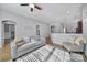 Bright and airy living room features hardwood flooring, a gray sofa, ceiling fan, and natural light at 224 Mills Ln, Fort Mill, SC 29708