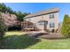 Charming backyard featuring a deck with pergola, stone patio, and lush lawn at 2283 Iron Works Dr, Clover, SC 29710