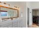 Bathroom featuring double sinks, updated vanity, and a large framed mirror, offering a clean and functional design at 2283 Iron Works Dr, Clover, SC 29710