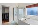 Elegant bathroom with a large soaking tub, a clear glass shower, and a view into a spacious walk-in closet at 2283 Iron Works Dr, Clover, SC 29710