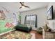 Playful bedroom features a dinosaur mural, a green bedspread, and hardwood floors at 2283 Iron Works Dr, Clover, SC 29710