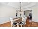 Bright dining room featuring hardwood floors, wainscoting, and a stylish chandelier at 2283 Iron Works Dr, Clover, SC 29710