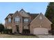Attractive brick two-story home with a well-kept lawn and an attached two-car garage at 2283 Iron Works Dr, Clover, SC 29710