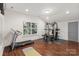 Spacious home gym with natural light, wood flooring, and various exercise equipment, perfect for staying active at 2283 Iron Works Dr, Clover, SC 29710