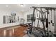 Bright home gym features mirrored wall, exercise equipment, and hardwood floors at 2283 Iron Works Dr, Clover, SC 29710