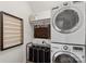 Well-organized laundry room featuring a stacked washer/dryer and storage at 2283 Iron Works Dr, Clover, SC 29710