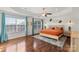 Sunlit main bedroom with tray ceiling, two windows and warm-toned decor, creating a serene and inviting atmosphere at 2283 Iron Works Dr, Clover, SC 29710