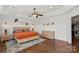 Spacious main bedroom with warm decor, a tray ceiling, and hardwood floors, providing an inviting and comfortable retreat at 2283 Iron Works Dr, Clover, SC 29710