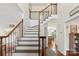 Elegant staircase with wood and iron railings, leading to a bright, open landing at 2283 Iron Works Dr, Clover, SC 29710