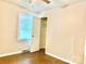 Bright bedroom featuring a window, hardwood floors, and a closet with an open door at 2314 Knickerbocker Dr, Charlotte, NC 28212