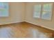 Spacious bedroom with two windows providing natural light and hardwood flooring at 2314 Knickerbocker Dr, Charlotte, NC 28212
