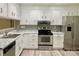 Well-lit kitchen with stainless steel appliances, white cabinets, and granite countertops at 2314 Knickerbocker Dr, Charlotte, NC 28212