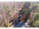 Overhead view of a wooded lot with a house nestled among the trees and a paved road leading to the property at 237 Creekstone Ln, York, SC 29745