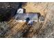 Aerial view of a home with a deck, storage buildings, and surrounding bare trees at 237 Creekstone Ln, York, SC 29745
